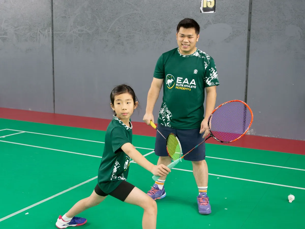 Lead coach Oscar Jap watching a junior player hold her stance on court