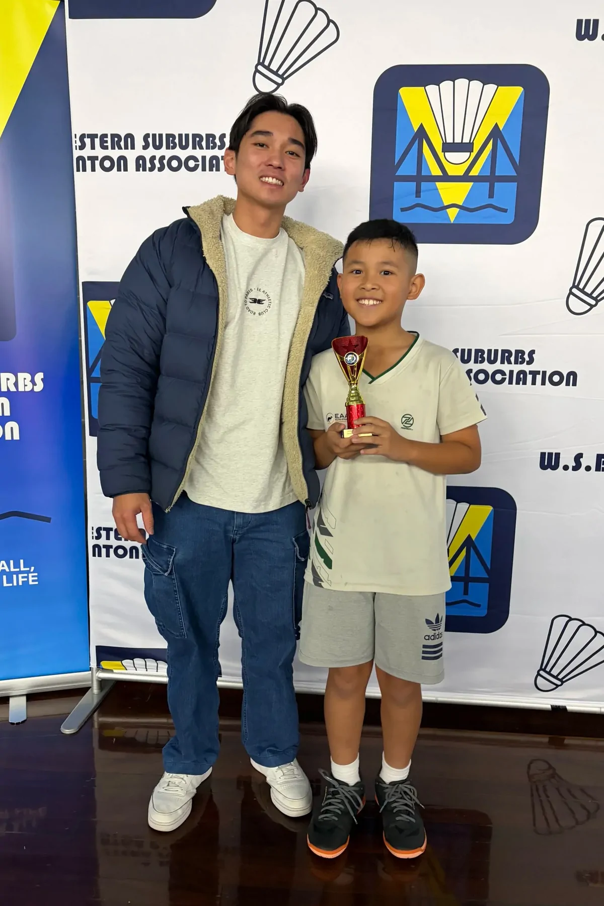 Izak with his coach after a tournament win